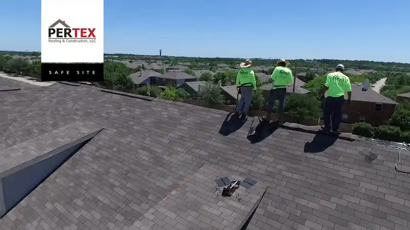 PERTEX Roofing crew in company shirts on shingle roof